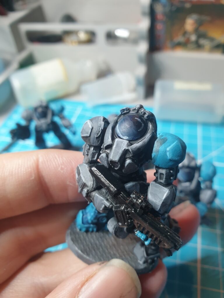 A close up of one of the space marines shoeing the edge highlights on the armour and the highlights and shading in their helmets.