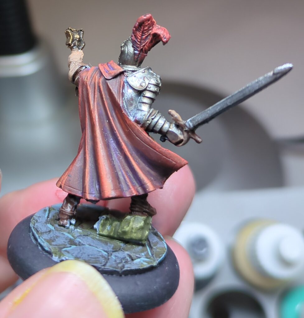 Fransisco Vargas viewed from the back, showing off the shading of his flowing red cape.