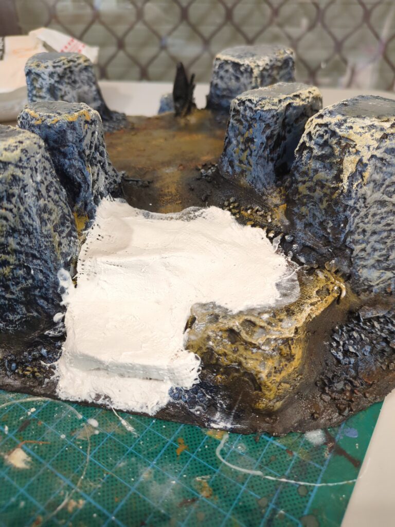 A close up of a plaster mountain, fresh plaster has been added to create a series of ledges.