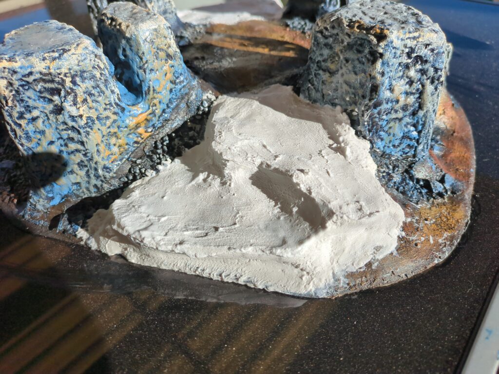 A close up of another side of the plaster mountain, fresh plaster has been added to this side too, creating another series of ledges.