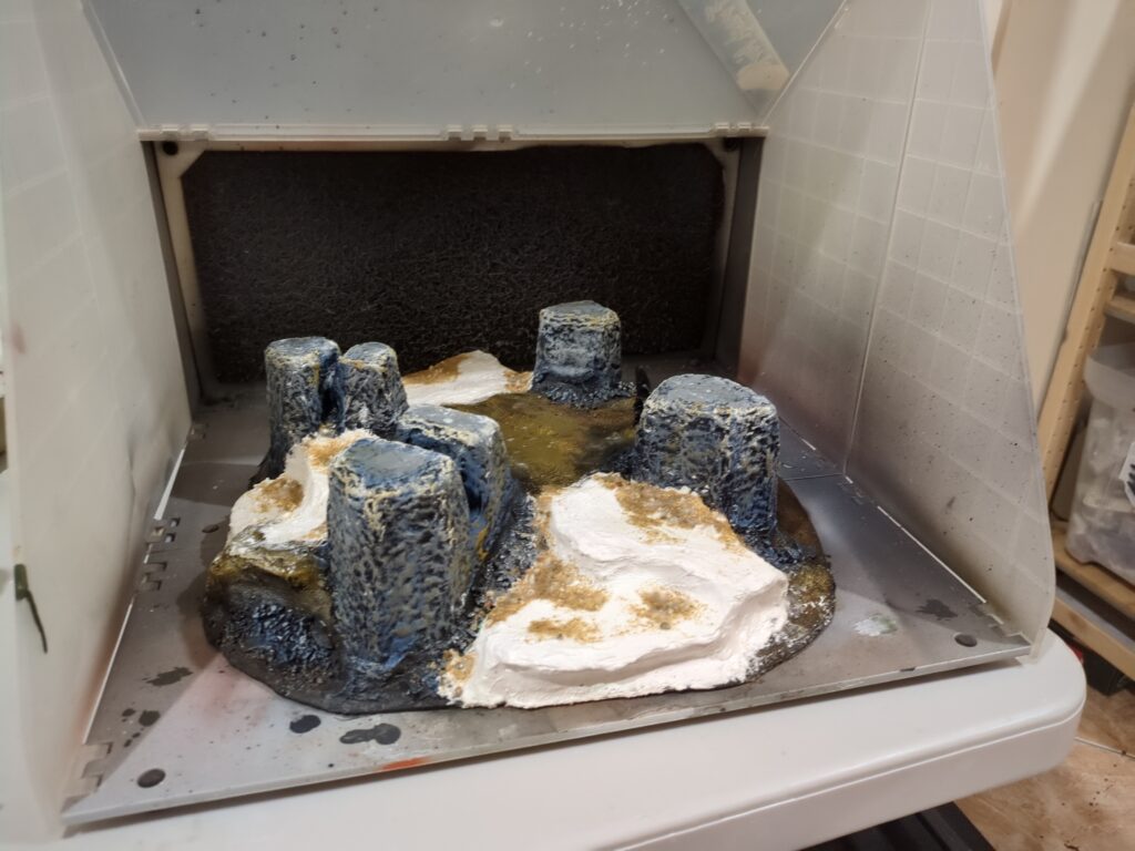 An overview showing the hills with the new plaster ledges. Rocks and sand have been added to the surface to create texture.