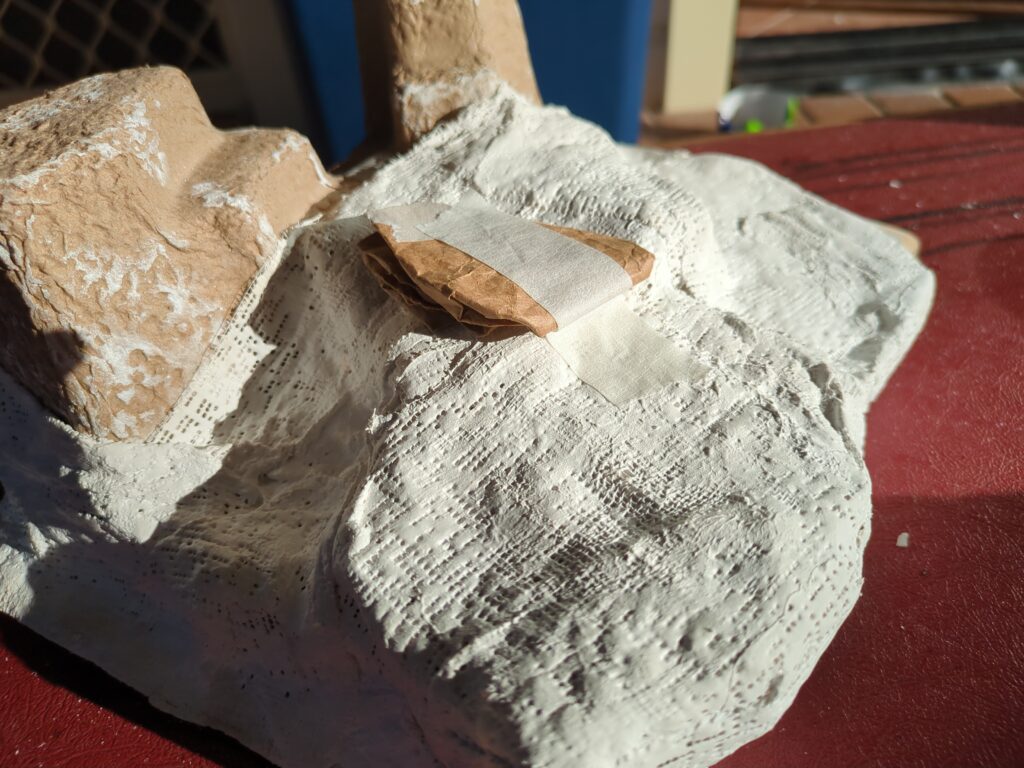 A rough plaster hill, with some additional paper added to help adjust its shape.