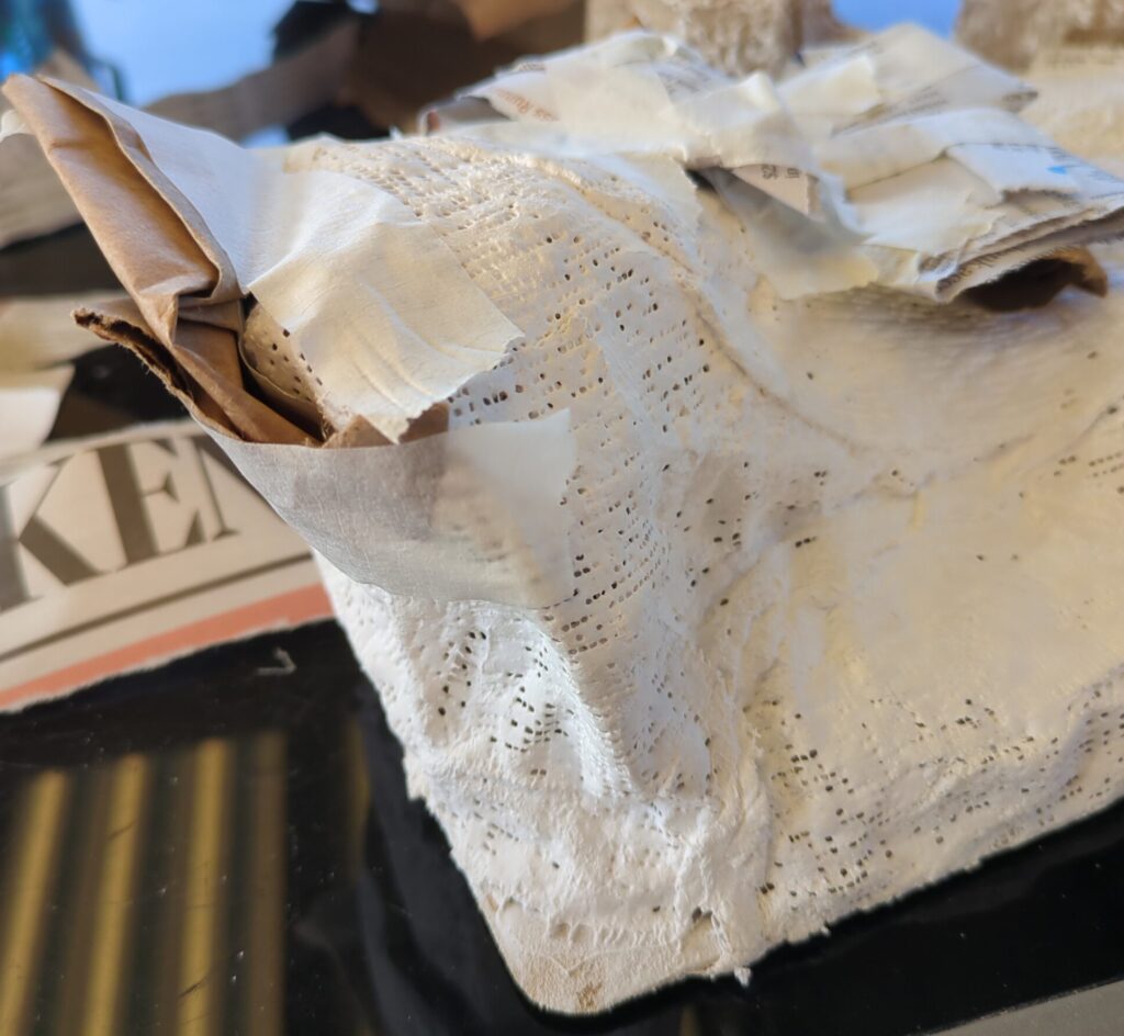 Close up of a plaster hill, in addition to the material added to build up ledges, the top edge has been built out slightly to create an overhang.